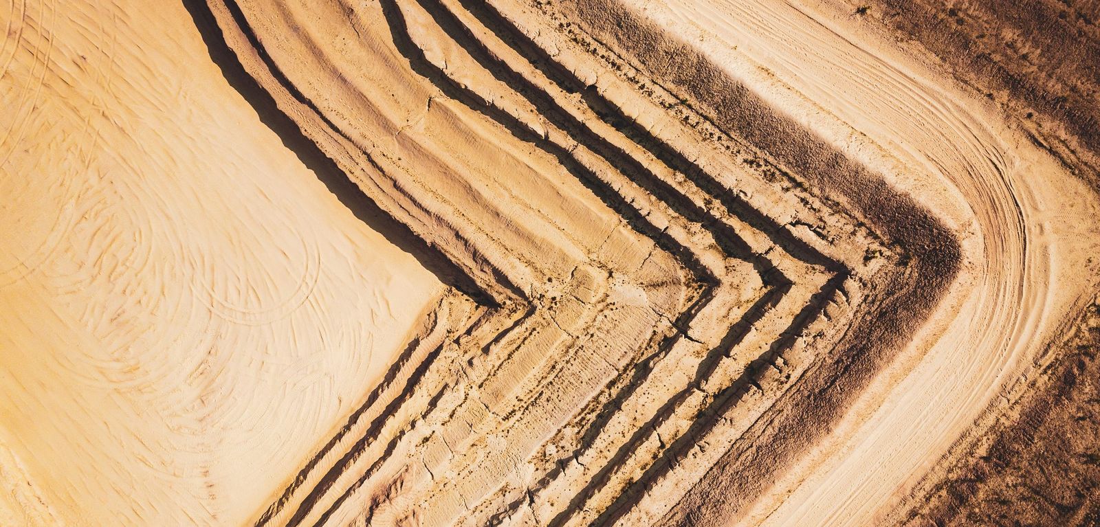 Aerial view of terraced excavation benches at an open mine